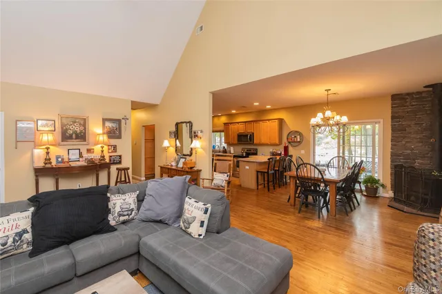 a living room with lots of furniture and a large window