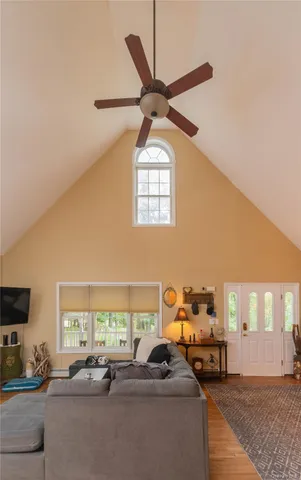 a living room with furniture a ceiling fan and a window