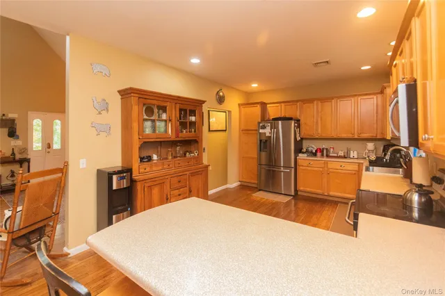 a kitchen with stainless steel appliances a refrigerator and wooden cabinets