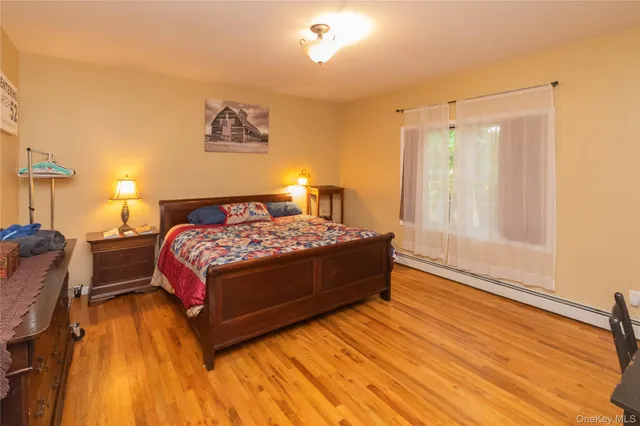 a large bed sitting in a bedroom next to a window