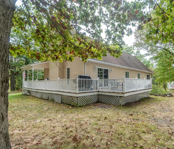 a front view of a house with a garden and deck