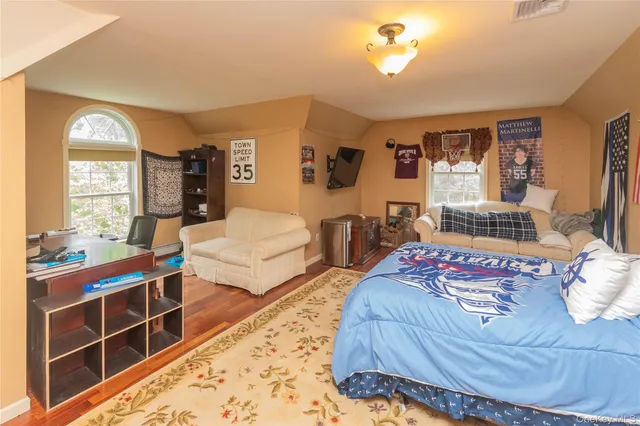 a bedroom with a large bed and a dresser