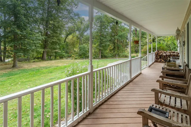 a view of a balcony with chairs and wooden floor