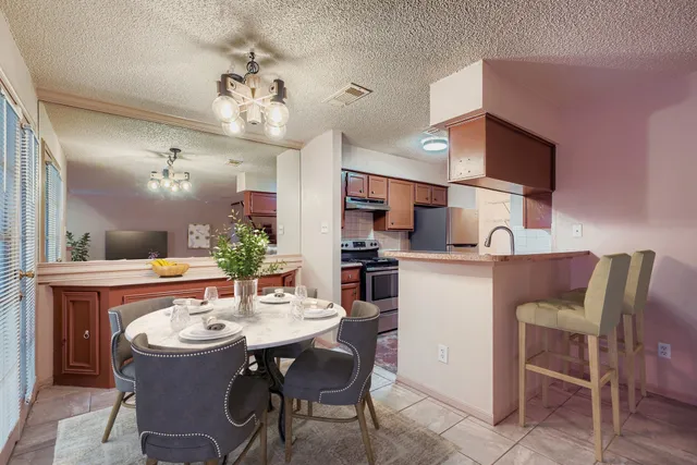 a kitchen with stainless steel appliances granite countertop a sink and a refrigerator