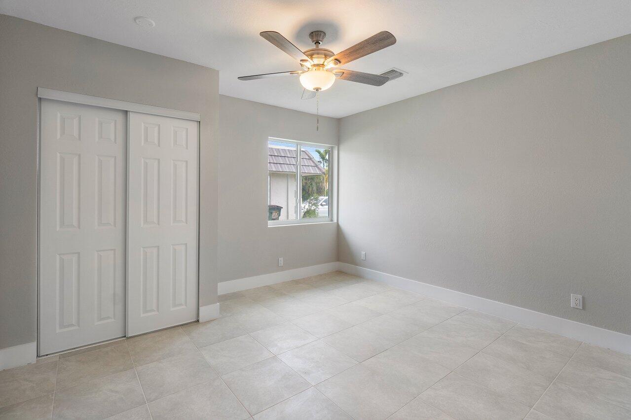 245 Southwest 6th Street Boca Raton, FL 33432 - Photo 11 of 40 an empty room with window and a ceiling fan