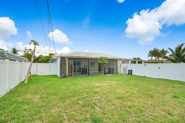 a view of a house with a yard and sitting area