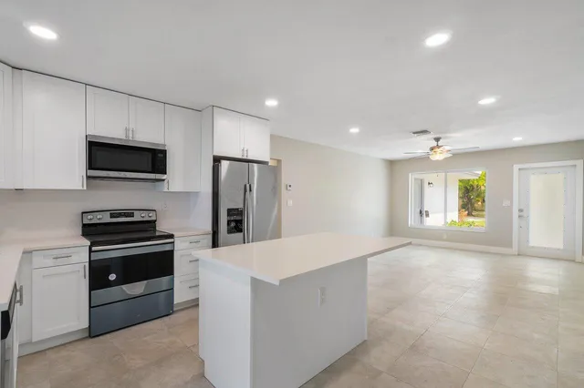a kitchen with refrigerator and microwave