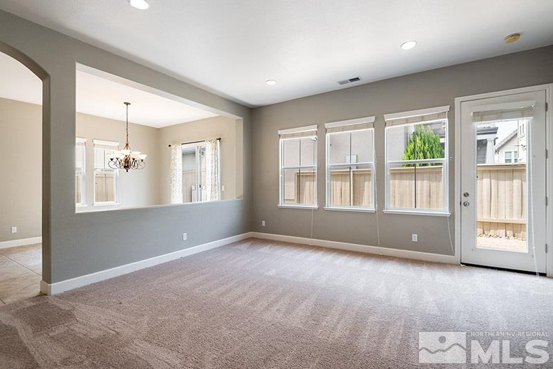 7677 Stone Bluff Way Reno, NV 89523 - Photo 2 of 17 a view of an empty room with a window and wooden floor