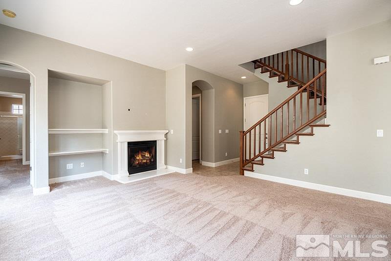 7677 Stone Bluff Way Reno, NV 89523 - Photo 3 of 17 a view of an empty room with stairs and a fireplace