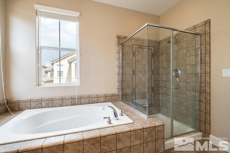 7677 Stone Bluff Way Reno, NV 89523 - Photo 9 of 17 a bathroom with a bathtub and shower