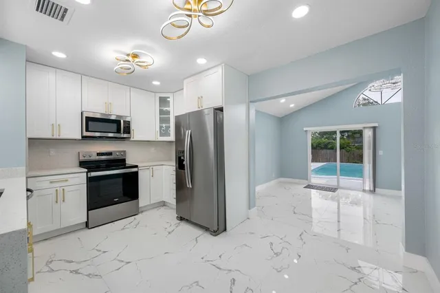 a kitchen with a sink stainless steel appliances and cabinets