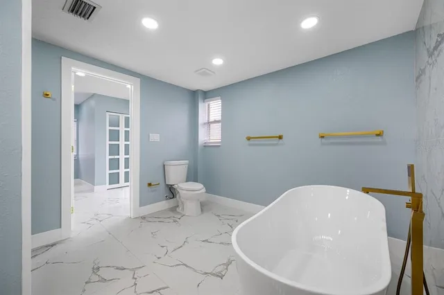 a bathroom with a bathtub and sink