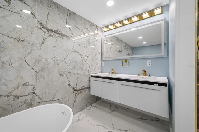 a bathroom with a tub sink toilet and shower