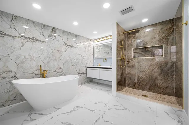 a bathroom with a bathtub and shower