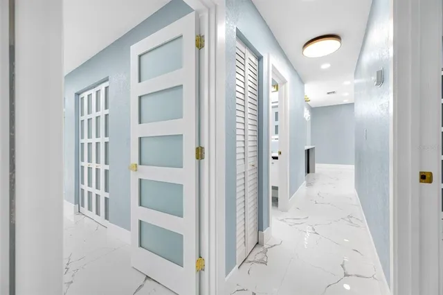 a white toilet sitting next to a bathroom sink and a shower