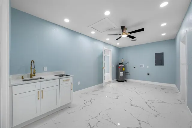 a view of a livingroom with a ceiling fan and a wooden floor