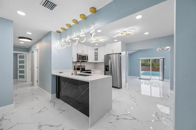 a kitchen with refrigerator and cabinets