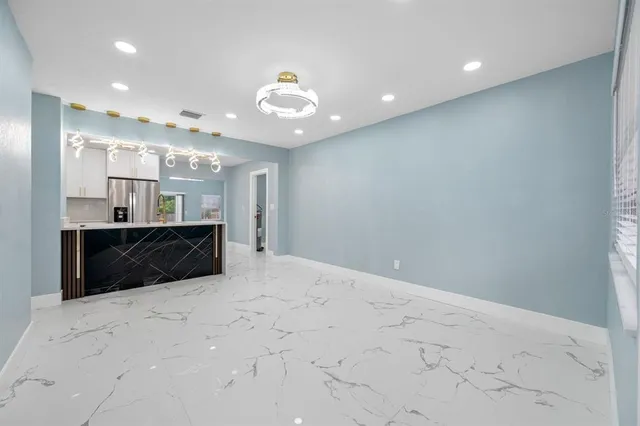 a large white kitchen with a large window