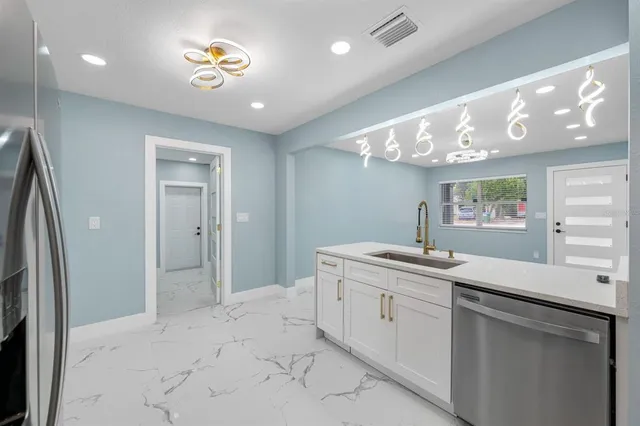 a kitchen with stainless steel appliances a refrigerator and cabinets