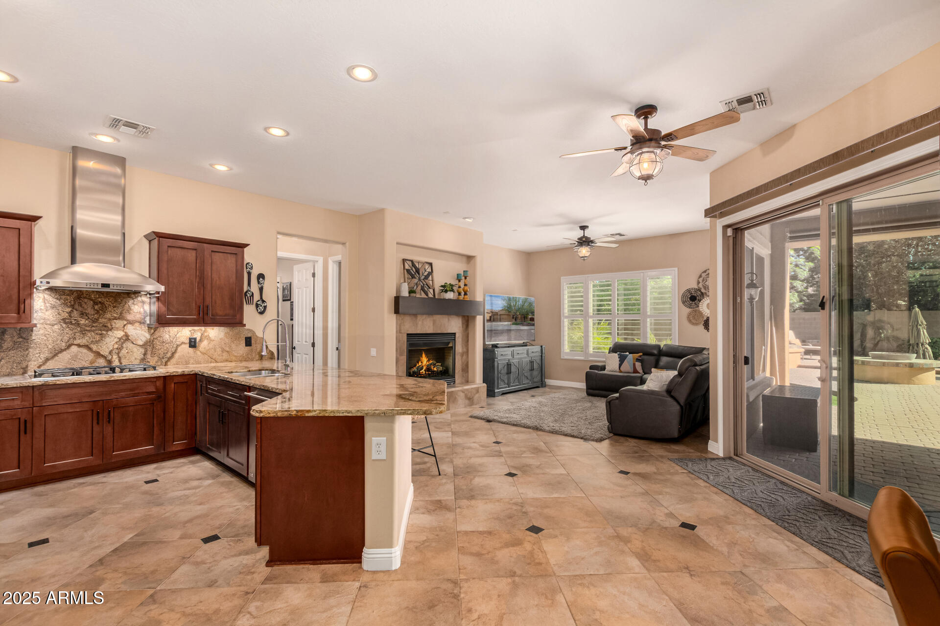 5523 West Yearling Road Phoenix, AZ 85083 - Photo 19 of 54 a large living room with stainless steel appliances kitchen island granite countertop furniture and a fireplace