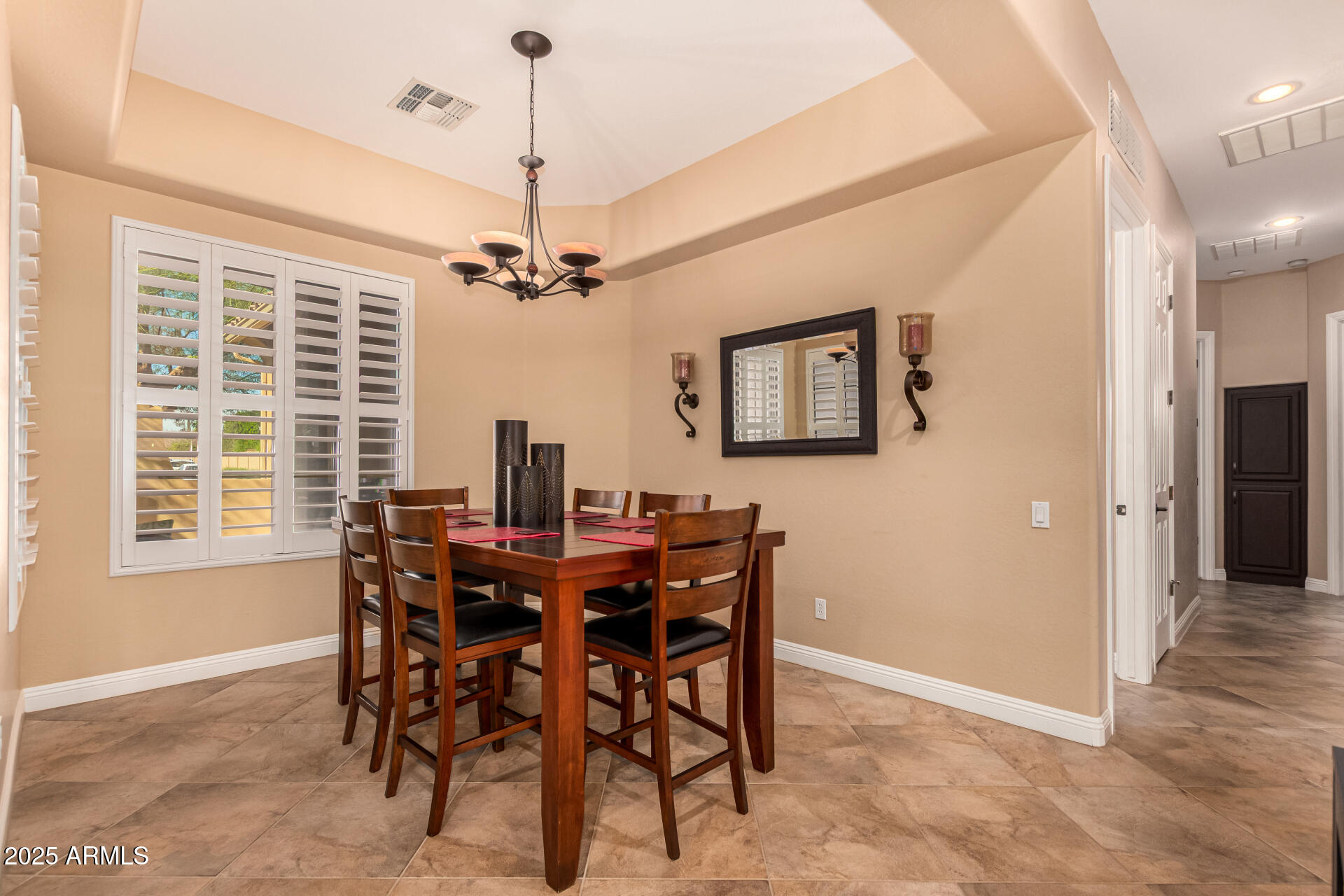 5523 West Yearling Road Phoenix, AZ 85083 - Photo 27 of 54 a view of a dining room with furniture and a chandelier