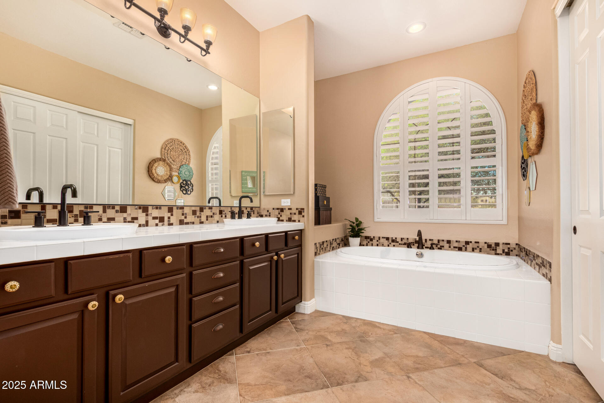 5523 West Yearling Road Phoenix, AZ 85083 - Photo 31 of 54 a spacious bathroom with a tub sink and mirror