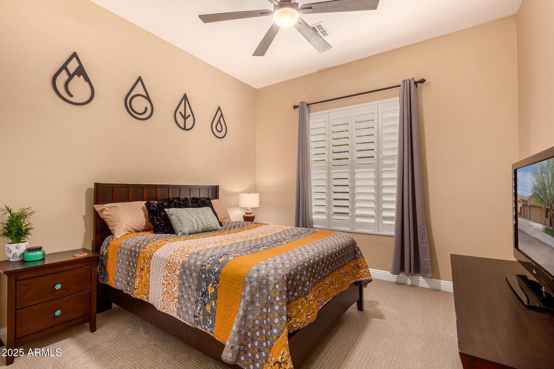 5523 West Yearling Road Phoenix, AZ 85083 - Photo 33 of 54 a bedroom with a bed and a flat tv screen on dresser
