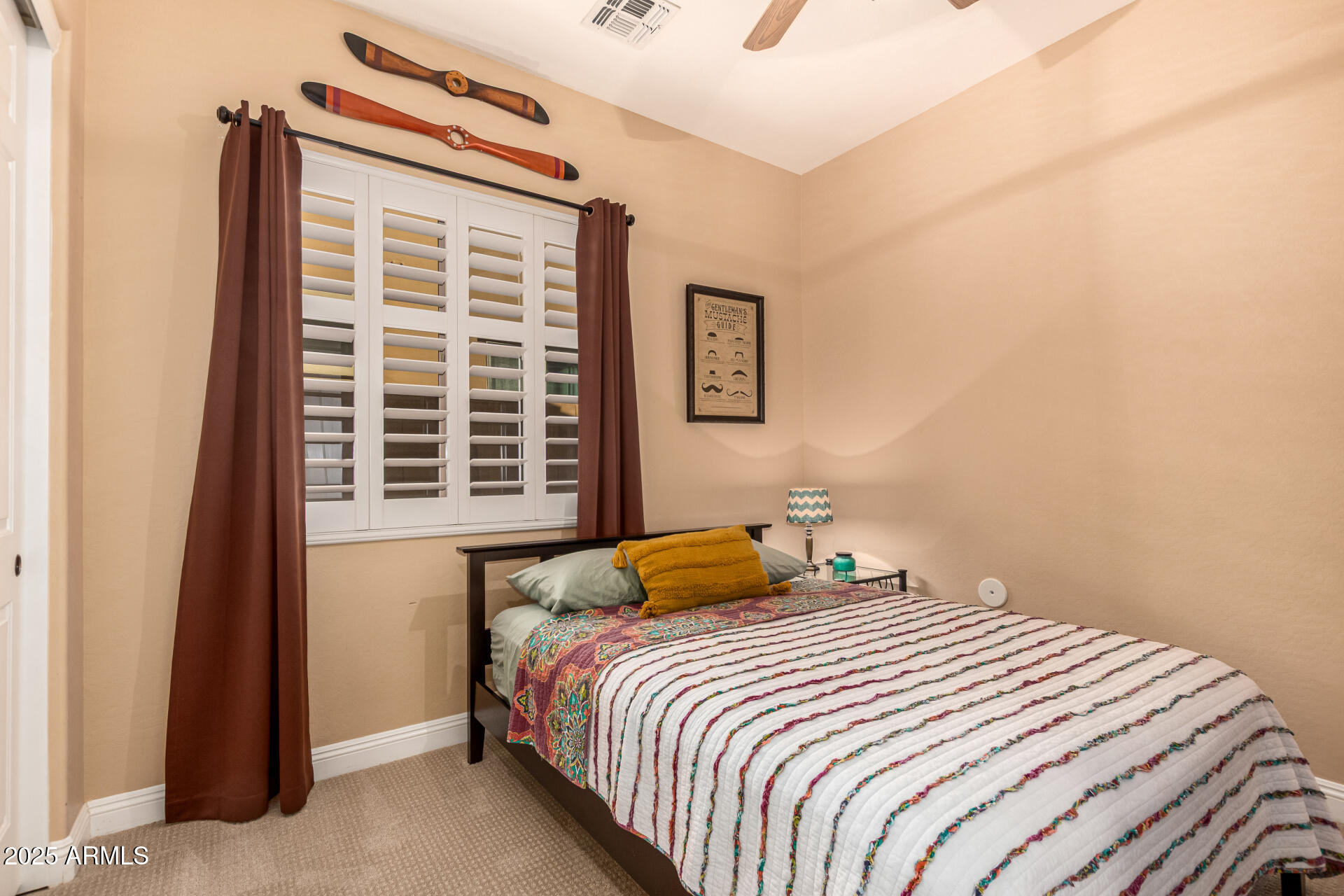 5523 West Yearling Road Phoenix, AZ 85083 - Photo 34 of 54 a bedroom with a bed and a window