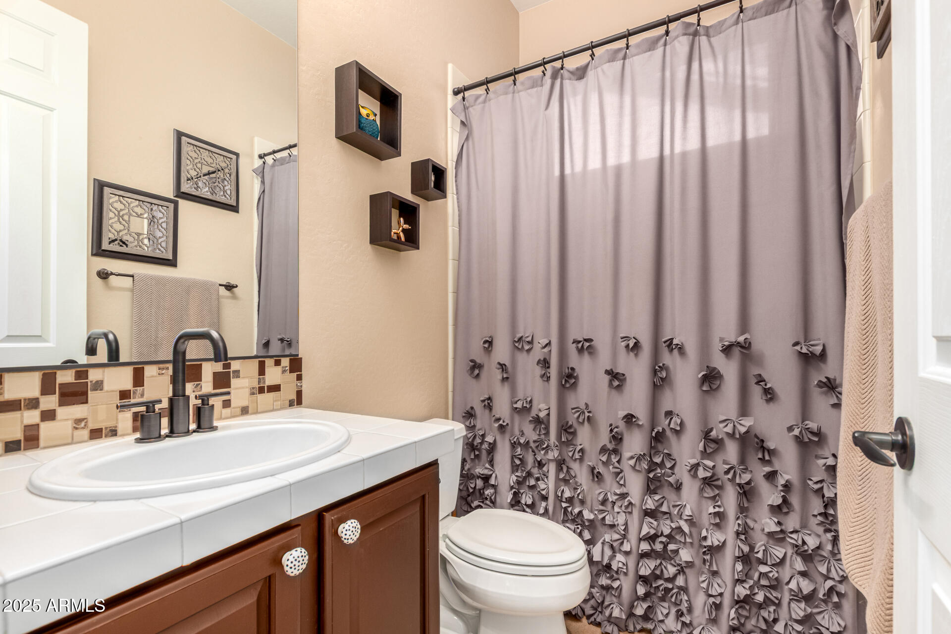 5523 West Yearling Road Phoenix, AZ 85083 - Photo 36 of 54 a bathroom with a sink toilet and shower