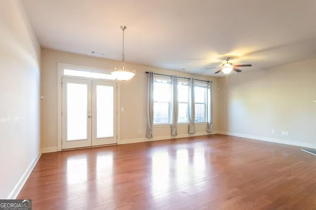 a view of a room with wooden floor and a window