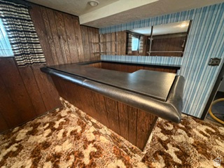 588 North 4500 West West Point, UT 84015 - Photo 29 of 61 Built-in bar with dark countertop and wood-paneling base