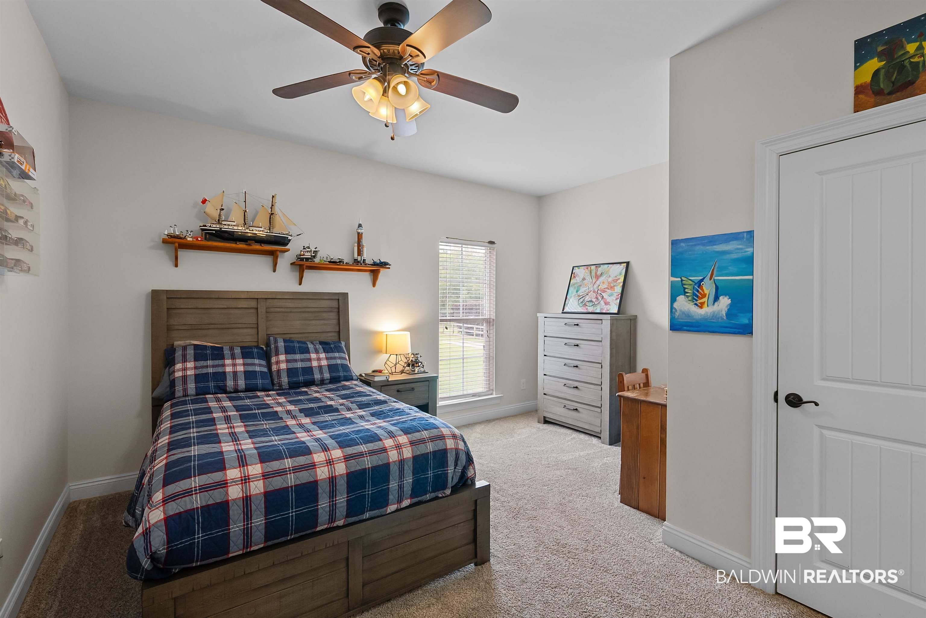 12070 Comalander Road Fairhope, AL 36532 - Photo 33 of 50 Bedroom featuring light beige wall color, ceiling fan with integrated lighting, wood-finish flooring, and a window with blinds