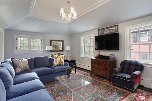 1162 Tower Road Winnetka, IL 60093 - Photo 5 of 13 a living room with furniture a chandelier and a flat screen tv