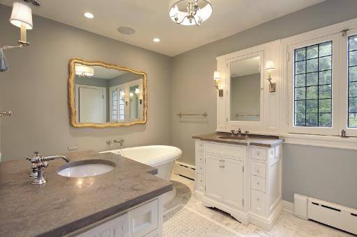 1162 Tower Road Winnetka, IL 60093 - Photo 8 of 13 a bathroom with a granite countertop sink a toilet and mirror
