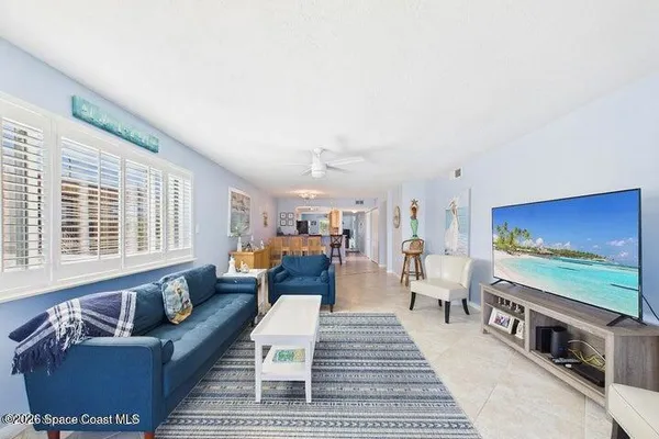 a living room with furniture and a floor to ceiling window