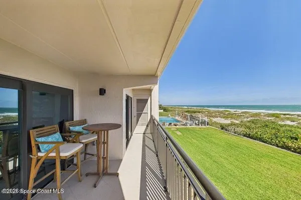 a kitchen with stainless steel appliances kitchen island granite countertop a table chairs and a refrigerator