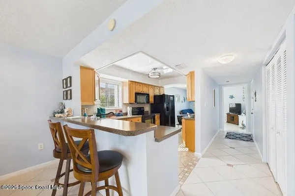 a kitchen with stainless steel appliances granite countertop a sink counter space and a dining table