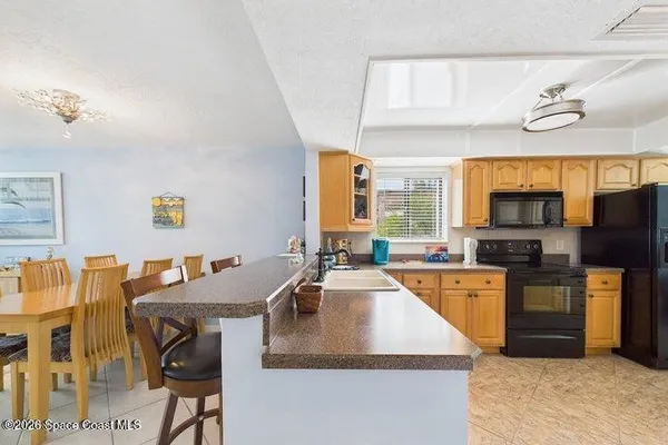 a kitchen with stainless steel appliances granite countertop a sink a stove and refrigerator