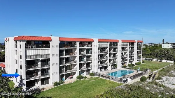 a front view of a building with a garden