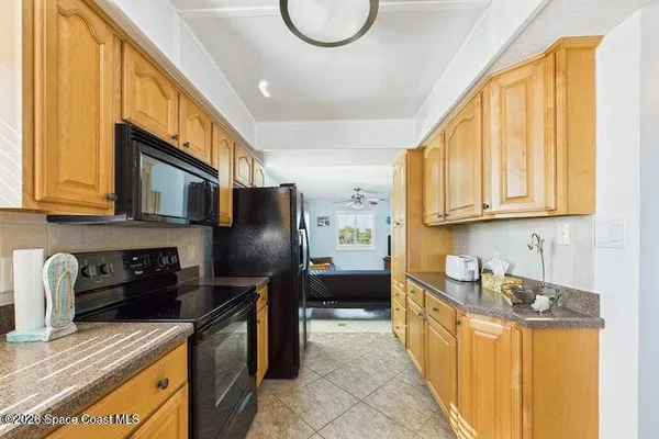 a living room with furniture and painting on the wall