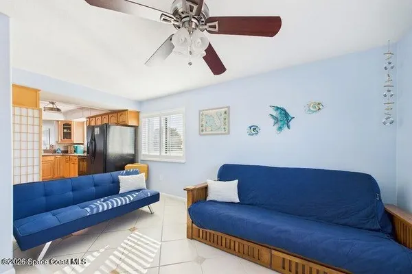a living room with furniture a flat screen tv and a window