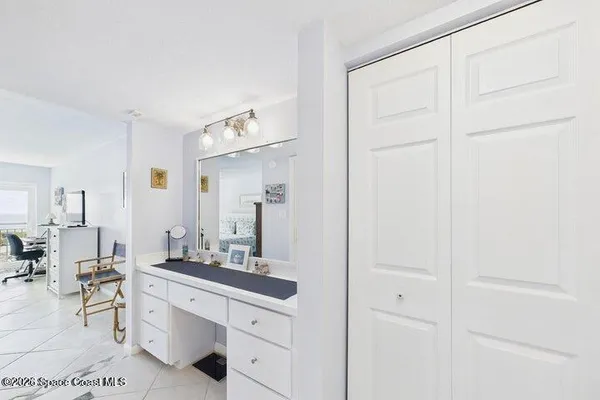 a spacious bathroom with a double vanity sink a mirror and a shower