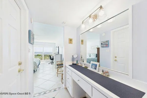 a bedroom with a bed couch and window