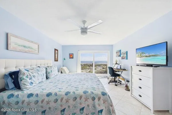 a bedroom with a bed a couch and dresser