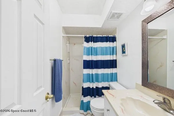 a patio with water view fountain and ocean view
