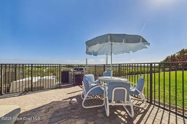 a view of a building with garden and sitting area