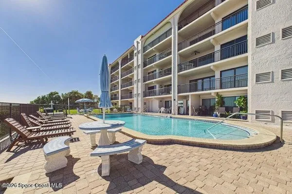 a view of a swimming pool and an outdoor seating