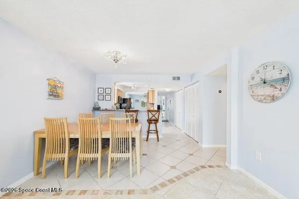 a living room with furniture and kitchen view
