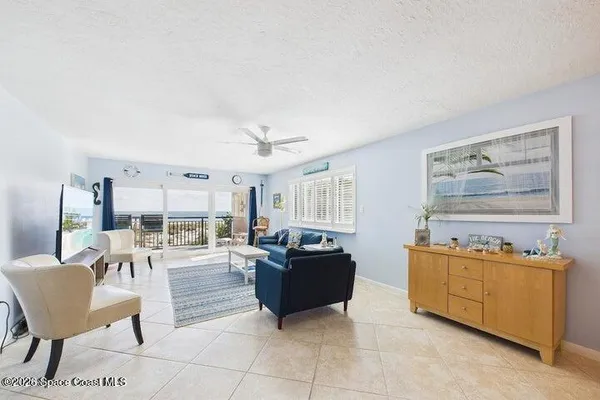 a living room with furniture and a flat screen tv with wooden floor