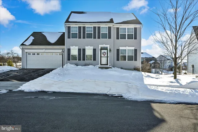 a kitchen with stainless steel appliances granite countertop a stove a refrigerator a kitchen island a dining table and chairs